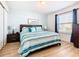 Main bedroom with striped bedding and window at 1610 Lima Ave, Kissimmee, FL 34747