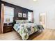 Main bedroom with dark-blue accent wall and ensuite bathroom at 1610 Lima Ave, Kissimmee, FL 34747