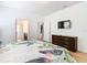 Bedroom with a dresser, TV, and floral bedding at 1610 Lima Ave, Kissimmee, FL 34747