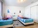 Charming bedroom with twin beds, nightstand, and Frozen themed bedding at 1610 Lima Ave, Kissimmee, FL 34747