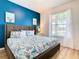 Primary bedroom with king bed and blue accent wall at 1610 Lima Ave, Kissimmee, FL 34747