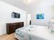 Bedroom with dresser, TV, and coastal bedding at 1610 Lima Ave, Kissimmee, FL 34747