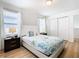 Bedroom with a queen bed, nightstands, and white closet doors at 1610 Lima Ave, Kissimmee, FL 34747