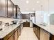 Large kitchen with dark cabinets and stainless steel appliances at 1610 Lima Ave, Kissimmee, FL 34747
