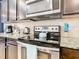 Modern kitchen with stainless steel appliances and granite counters at 1610 Lima Ave, Kissimmee, FL 34747