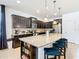 Modern kitchen with a large island and dark wood cabinets at 1610 Lima Ave, Kissimmee, FL 34747