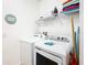 Bright laundry room with washer, dryer, and shelving at 1610 Lima Ave, Kissimmee, FL 34747