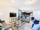 Open living room featuring comfortable seating, large TV, and adjacent kitchen at 1610 Lima Ave, Kissimmee, FL 34747