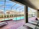 Enclosed pool and spa with lounge chairs; a private oasis at 1610 Lima Ave, Kissimmee, FL 34747