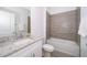 Bathroom with granite countertop, bathtub and tile shower at 1811 Coriander Dr, Kissimmee, FL 34759