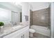 Bathroom with granite vanity, bathtub and tile surround at 1811 Coriander Dr, Kissimmee, FL 34759
