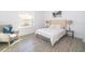 Bedroom with a bed, nightstand, and armchair near window at 1811 Coriander Dr, Kissimmee, FL 34759