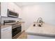 Stainless steel appliances and granite countertops in a modern kitchen at 1811 Coriander Dr, Kissimmee, FL 34759