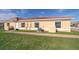 Tan single story home with red tile roof, walkway, and landscaping at 1849 Coriander Dr, Kissimmee, FL 34759