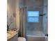 The bathroom features a shower-tub combination with light gray walls and a granite vanity at 19 James Ct, Davenport, FL 33837