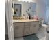 Stylish bathroom with a double sink vanity, granite countertops, and marble tile flooring at 19 James Ct, Davenport, FL 33837