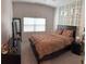 Main bedroom with a large bed, wall decor, and a TV stand at 19 James Ct, Davenport, FL 33837