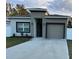 Attractive exterior with a one-car garage, manicured lawn, and modern color scheme at 19 James Ct, Davenport, FL 33837