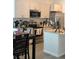 Modern kitchen with island, stainless steel appliances, and light-colored cabinets at 19 James Ct, Davenport, FL 33837