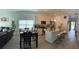 Open-concept kitchen with stainless steel appliances and granite countertops at 19 James Ct, Davenport, FL 33837