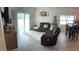 Living room with sectional sofa, dining area, and sliding door to backyard at 19 James Ct, Davenport, FL 33837