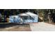 Newly renovated light blue house with white trim and a gravel driveway at 217 W Chelsea St, Deland, FL 32720