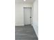 Interior view showing two white doors and grey flooring at 217 W Chelsea St, Deland, FL 32720