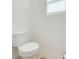 Small bathroom with white toilet and window at 2265 Tay Wes Dr, St Cloud, FL 34771