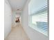 Bright and airy hallway with tile flooring connecting various rooms at 2265 Tay Wes Dr, St Cloud, FL 34771