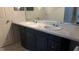 Bright bathroom featuring double sink vanity with marble countertop and updated fixtures at 228 Remington Pl, Haines City, FL 33844
