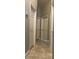 Hallway featuring three doors with neutral paint, white trim, and tile floors at 228 Remington Pl, Haines City, FL 33844
