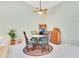 Bright dining area with a round glass-top table and four chairs at 2394 Sun Valley Cir # 2394, Winter Park, FL 32792