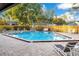 Community pool with lounge chairs and a surrounding patio at 2394 Sun Valley Cir # 2394, Winter Park, FL 32792