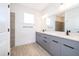 Modern bathroom with double vanity and gray cabinets at 2571 Sw 153Rd Lane, Ocala, FL 34473