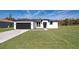 Modern home's exterior features a two-car garage and manicured lawn at 2571 Sw 153Rd Lane, Ocala, FL 34473