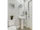Small bathroom with pedestal sink and toilet at 286 Begonia Ln, Kissimmee, FL 34759