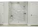Large walk-in shower with marble tile and bench at 286 Begonia Ln, Kissimmee, FL 34759