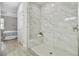 Large walk-in shower with marble tile and built-in seat at 286 Begonia Ln, Kissimmee, FL 34759