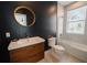 Modern bathroom with a white sink, bathtub, and dark-colored walls at 3000 Tohopekaliga Dr, St Cloud, FL 34772