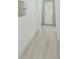 Bright hallway with light wood-look flooring and a large mirror at 3000 Tohopekaliga Dr, St Cloud, FL 34772