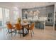 Modern kitchen with gray cabinetry, a large island, and wood dining table at 3000 Tohopekaliga Dr, St Cloud, FL 34772