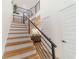 Modern staircase with metal railing and wood steps at 3000 Tohopekaliga Dr, St Cloud, FL 34772