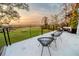 Deck overlooks tranquil water views at sunset; perfect for relaxing evenings at 3000 Tohopekaliga Dr, St Cloud, FL 34772