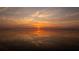 Spectacular sunset reflected on calm lake waters at 3000 Tohopekaliga Dr, St Cloud, FL 34772