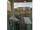 Balcony view of a grassy area and distant buildings, furnished with comfortable chairs and a glass-topped table at 3180 Paradox Cir # 102, Kissimmee, FL 34746
