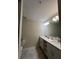 Bright bathroom features double sinks, modern lighting, and neutral-toned tile flooring at 3180 Paradox Cir # 102, Kissimmee, FL 34746