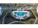 Aerial view of a stunning community pool surrounded by palm trees, lounge chairs, and well-maintained landscaping at 3180 Paradox Cir # 102, Kissimmee, FL 34746