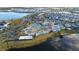 Wide aerial view of the community waterpark, with a lake, water slides, pools, and sports courts in a residential area at 3180 Paradox Cir # 102, Kissimmee, FL 34746