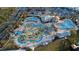 Aerial view of the community waterpark featuring slides, pools, mini golf, and beautifully landscaped areas at 3180 Paradox Cir # 102, Kissimmee, FL 34746