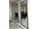 Dining room with floor to ceiling mirrors and grey geometric wallpaper at 3180 Paradox Cir # 102, Kissimmee, FL 34746